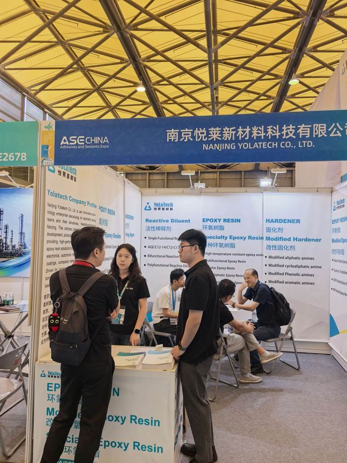 Visitors reviewing epoxy resin and hardener grades at the Yolatech booth E2676 during ASE CHINA 2026